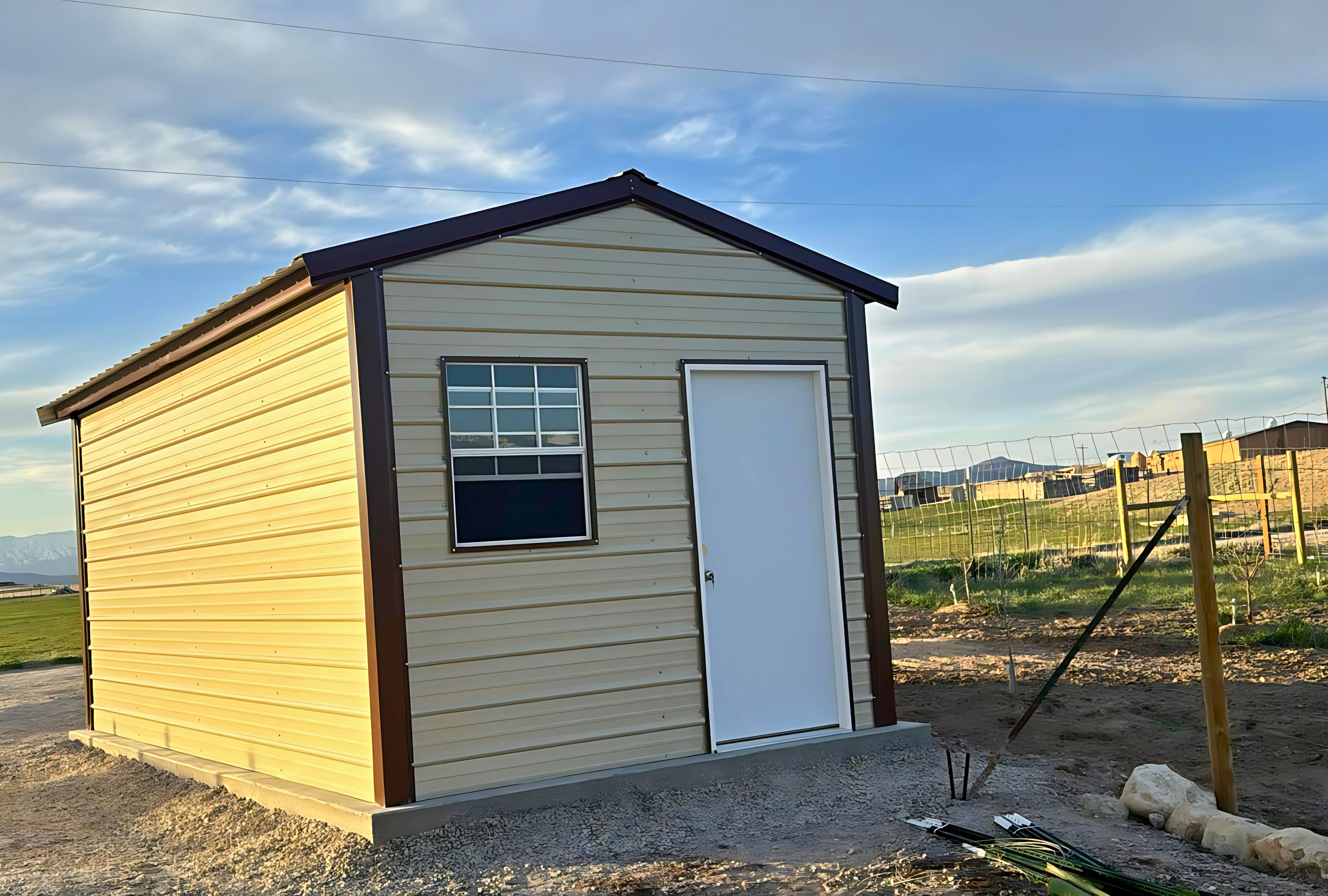 10'x20'x8' a-frame style vertical roof, heavy duty to withstand the snow, closed on both sides and the ends, with one walk in door, two windows & one 6' x 6' roll-up door.
