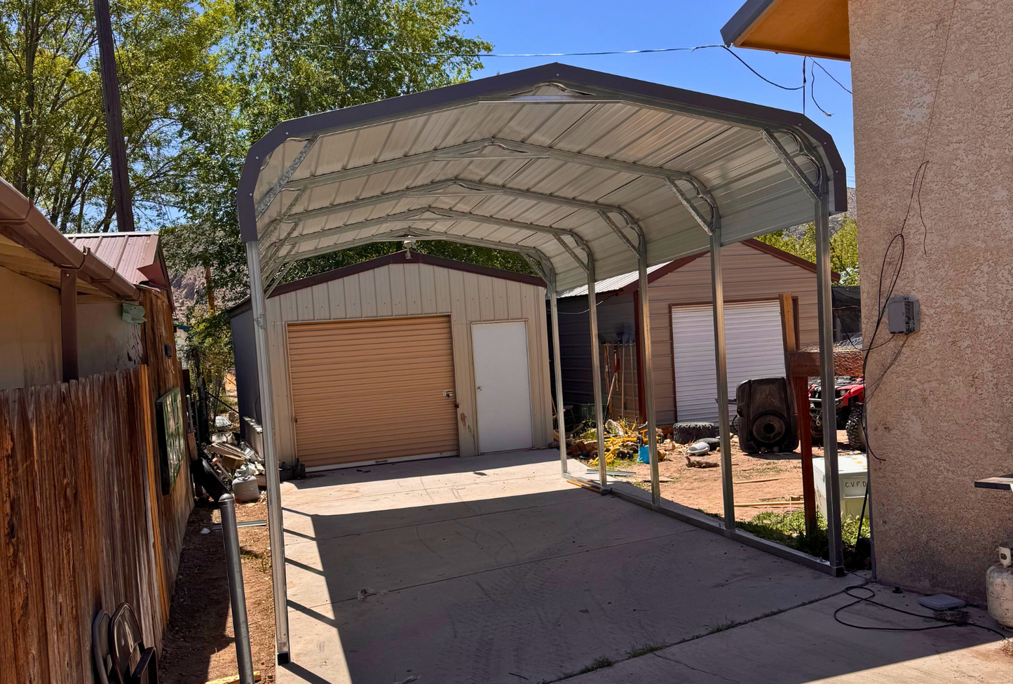12'x20'x8' charcoal gray roof with open sides for one vehicle only, front left sideways view.