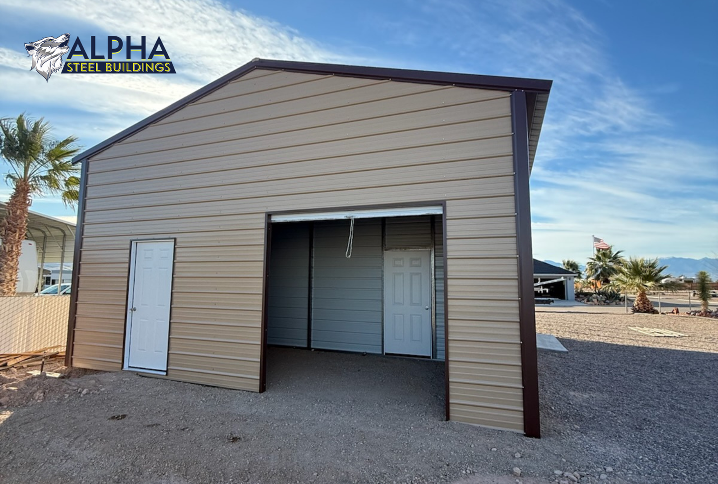 Rear angled view of 24x50 A-frame steel building with vertical roof, fully enclosed back end, 8x8 roll-up door, side frame-out opening, extra side panels, and 12-foot height.