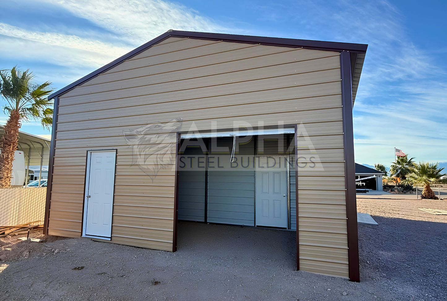 Rear angled view of 24x50 A-frame steel building with vertical roof, fully enclosed back end, 8x8 roll-up door, side frame-out opening, extra side panels, and 12-foot height.