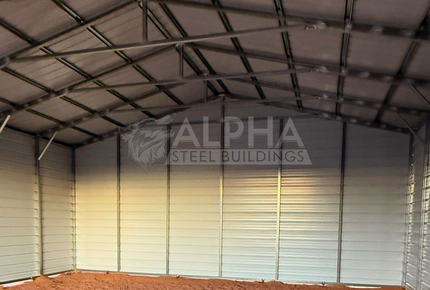 Interior view of 30x40 A-frame steel garage showing enclosed back wall, 14-gauge frame, and vertical roof panels.