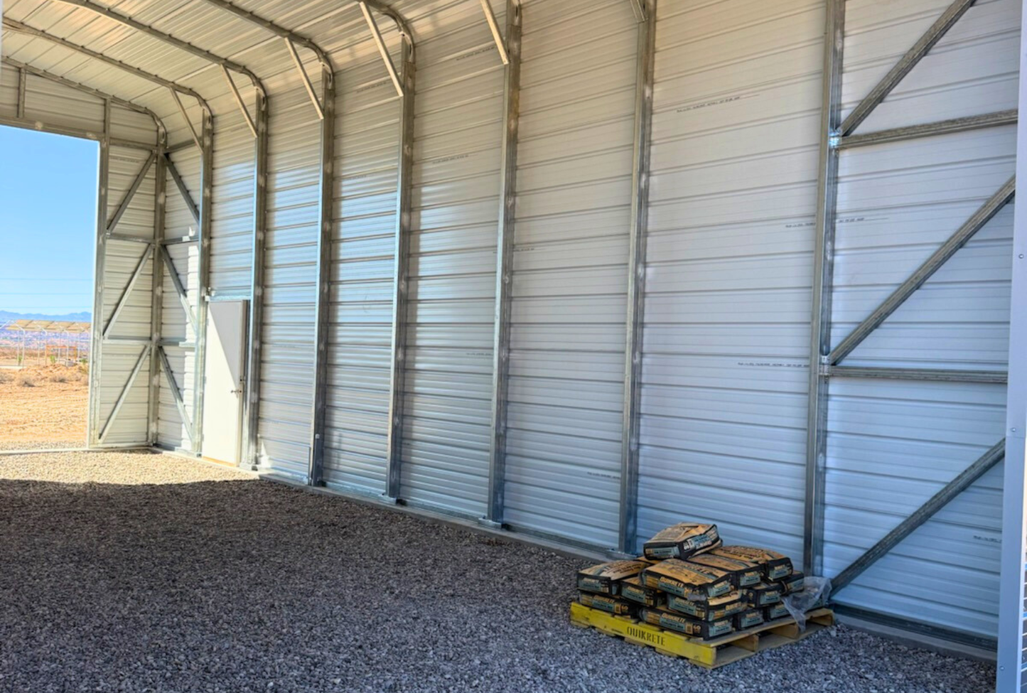 Interior view of 20x40 Regular Style steel building with 14-foot height, 14-gauge frame, diagonal bracing, double leg posts, and two 14x14 overhead door frame-outs, engineered for 30 PSF ground snow load.