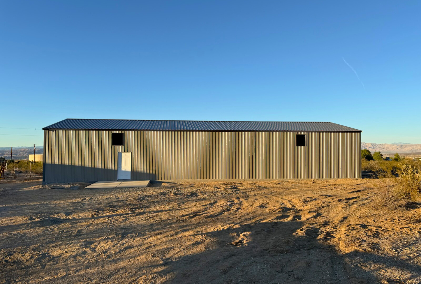 Left side exterior of a 30x80 A-frame metal building by Alpha Steel Buildings with vertical siding and closed ends — strong, low-maintenance steel construction.