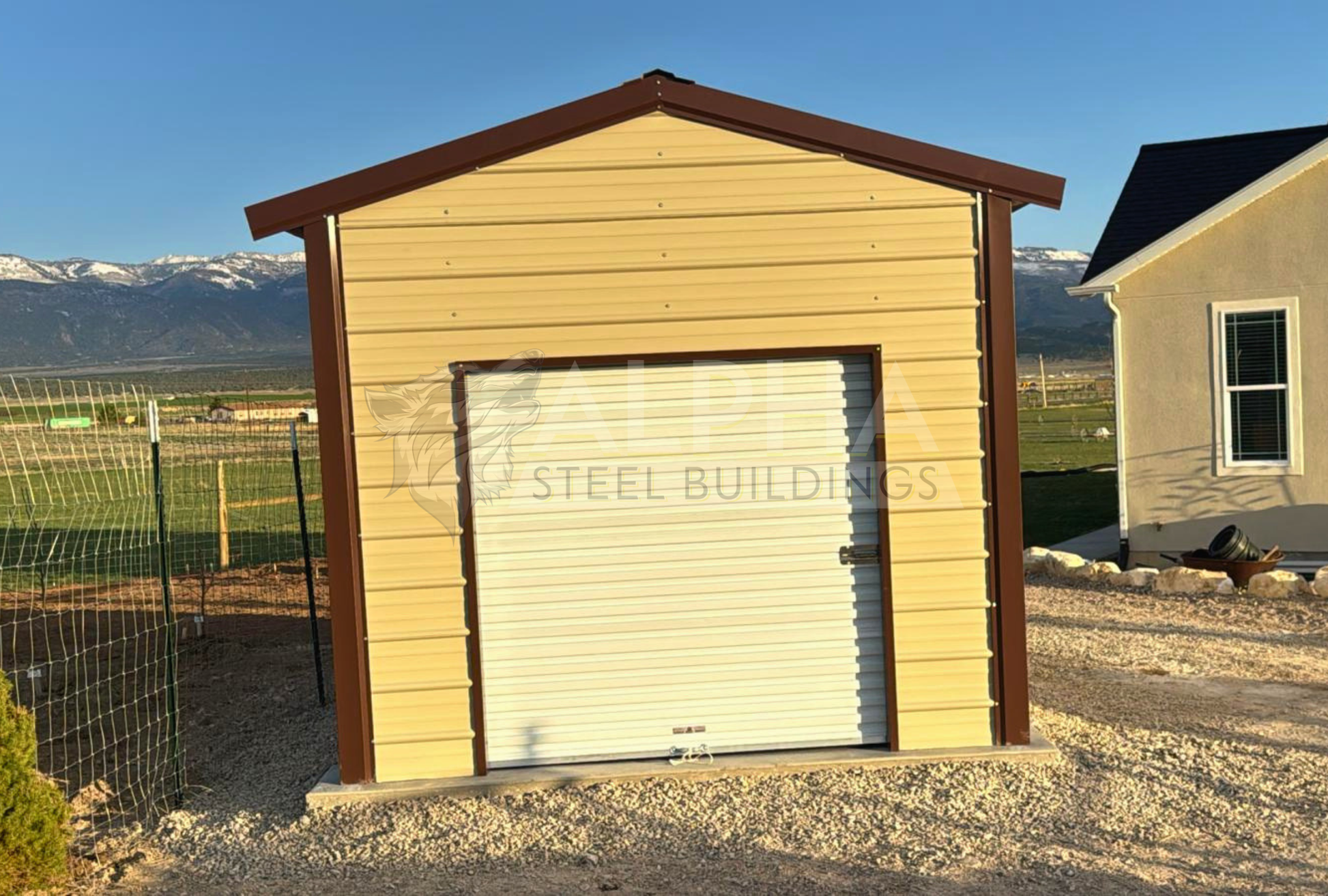 Back view of 10'x20'x8' a-frame style vertical roof steel storage shed, closed on both sides and the ends, with one walk in door, two windows & one 6' x 6' roll-up door.