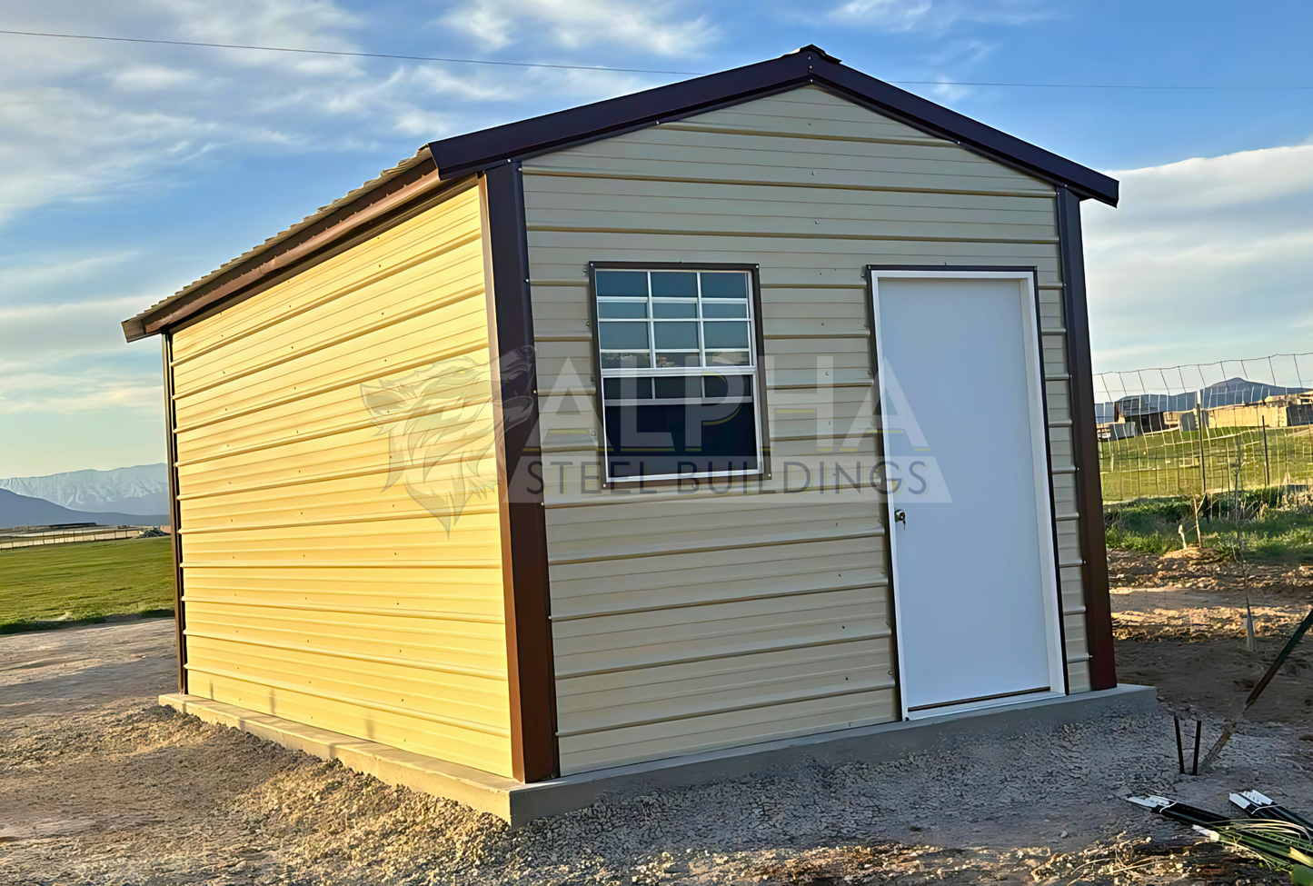 Front left angle view of 10'x20'x8' a-frame style vertical roof steel storage shed, closed on both sides and the ends, with one walk in door, two windows & one 6' x 6' roll-up door.