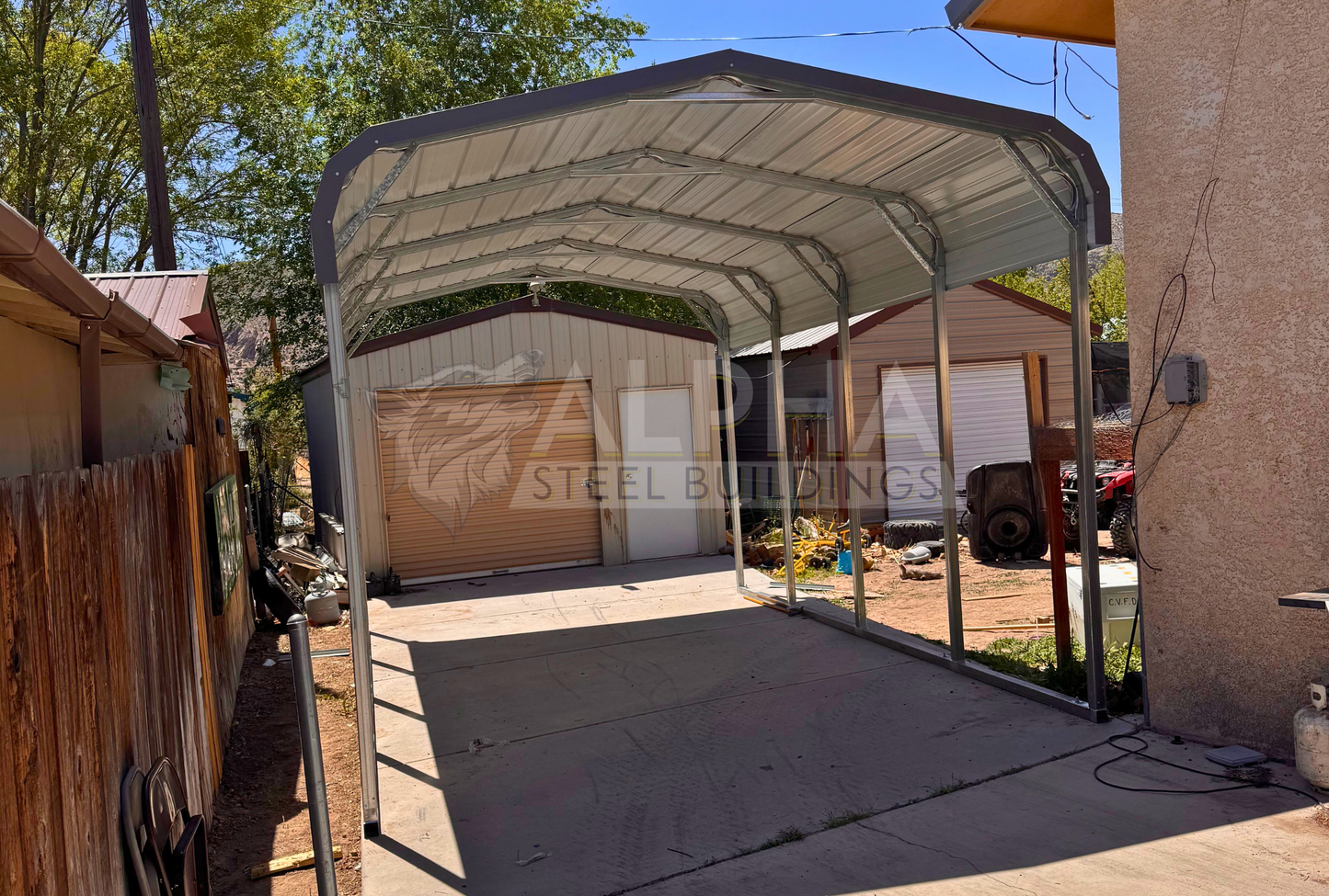 Front interior angle view of a 12x20x8 regular style steel carport showing the horizontal roof, 14-gauge steel frame, and open sides and ends.