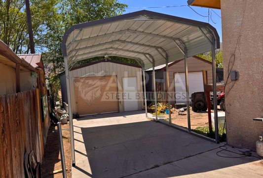 Front interior angle view of a 12x20x8 regular style steel carport showing the horizontal roof, 14-gauge steel frame, and open sides and ends.