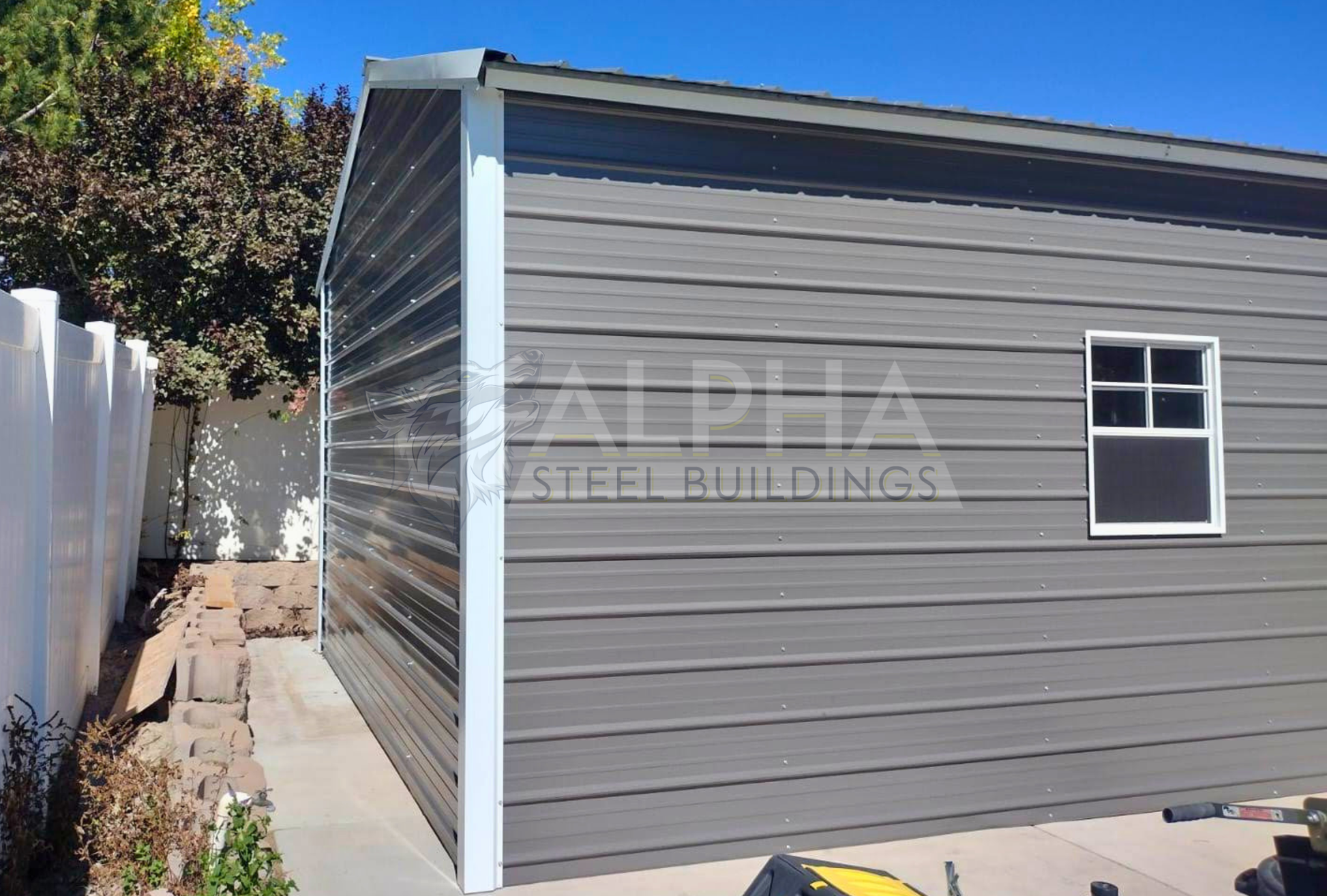 Side view of an 18x25x10 vertical roof steel garage showing horizontal wall panels, a 30x36 window, and the vertical roof system.