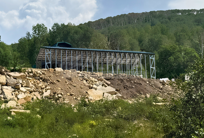 18'x44'x13' A-frame steel carport rear-side angled view showing vertical roof, open steel framing, and reinforced structural bracing.