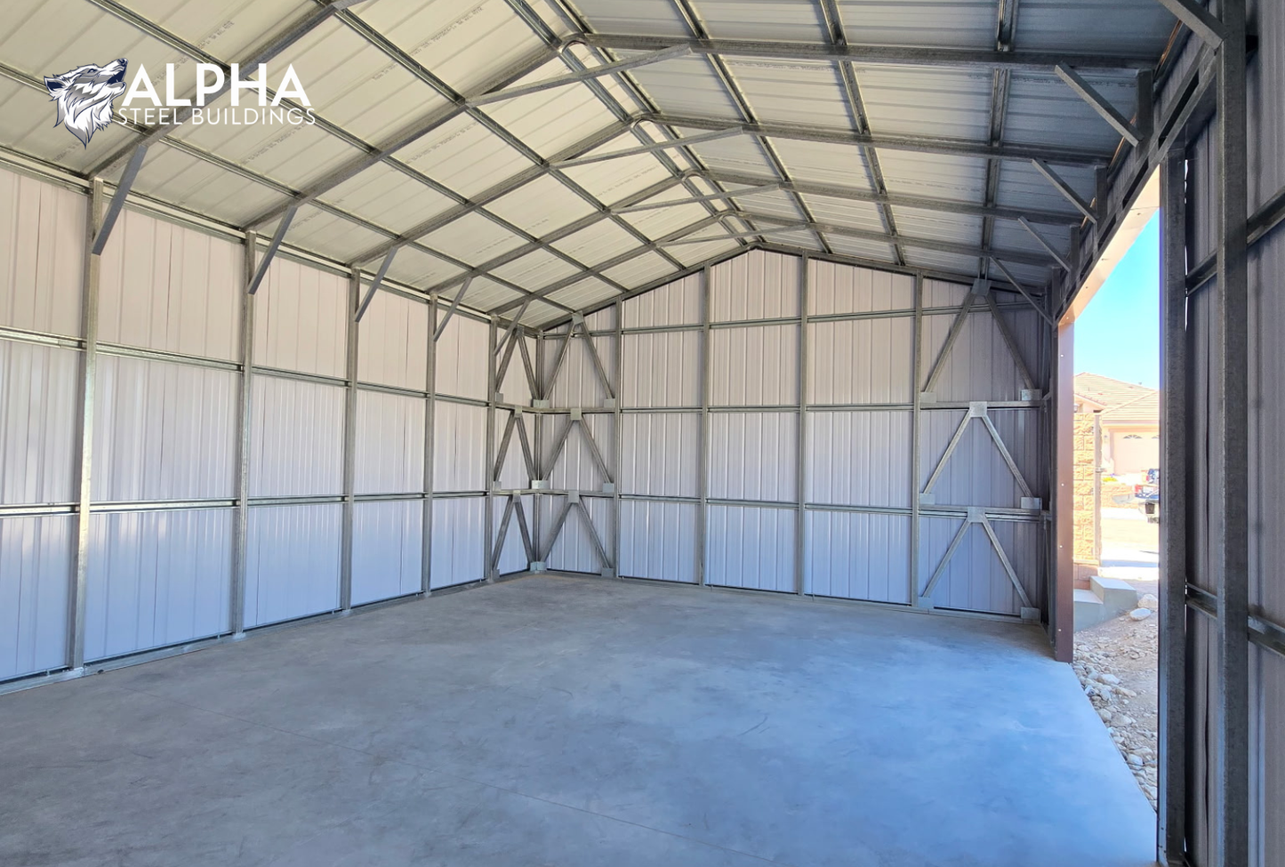 Interior view of 22x60x12 A-frame utility building showing vertical roof panels, enclosed back wall, and structural framing with bracing.