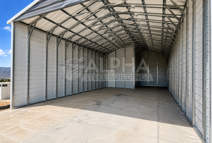Interior of a 24'x30'x12' vertical roof steel utility building featuring enclosed storage space, 14-gauge steel framing, vertical roof panels, and a walk-in door.