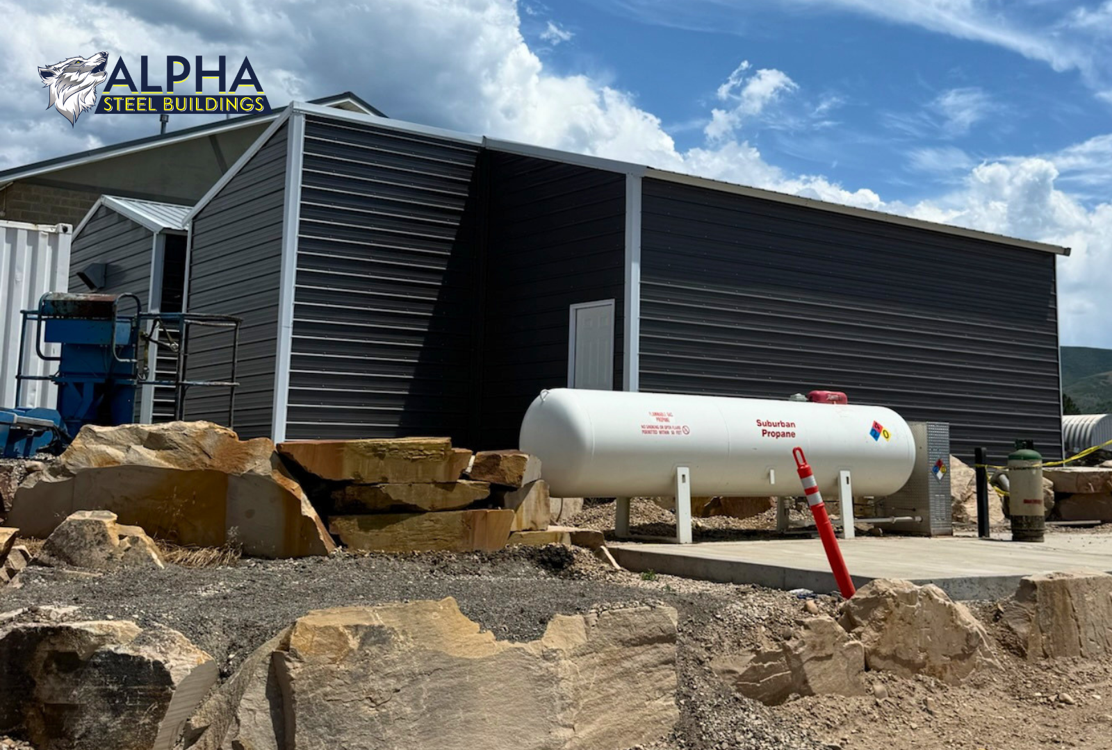 Back angled side exterior view of a 24'x30'x12' vertical roof steel utility building with a 12'x10' attached lean-to, enclosed side walls, and vertical roof metal panels.