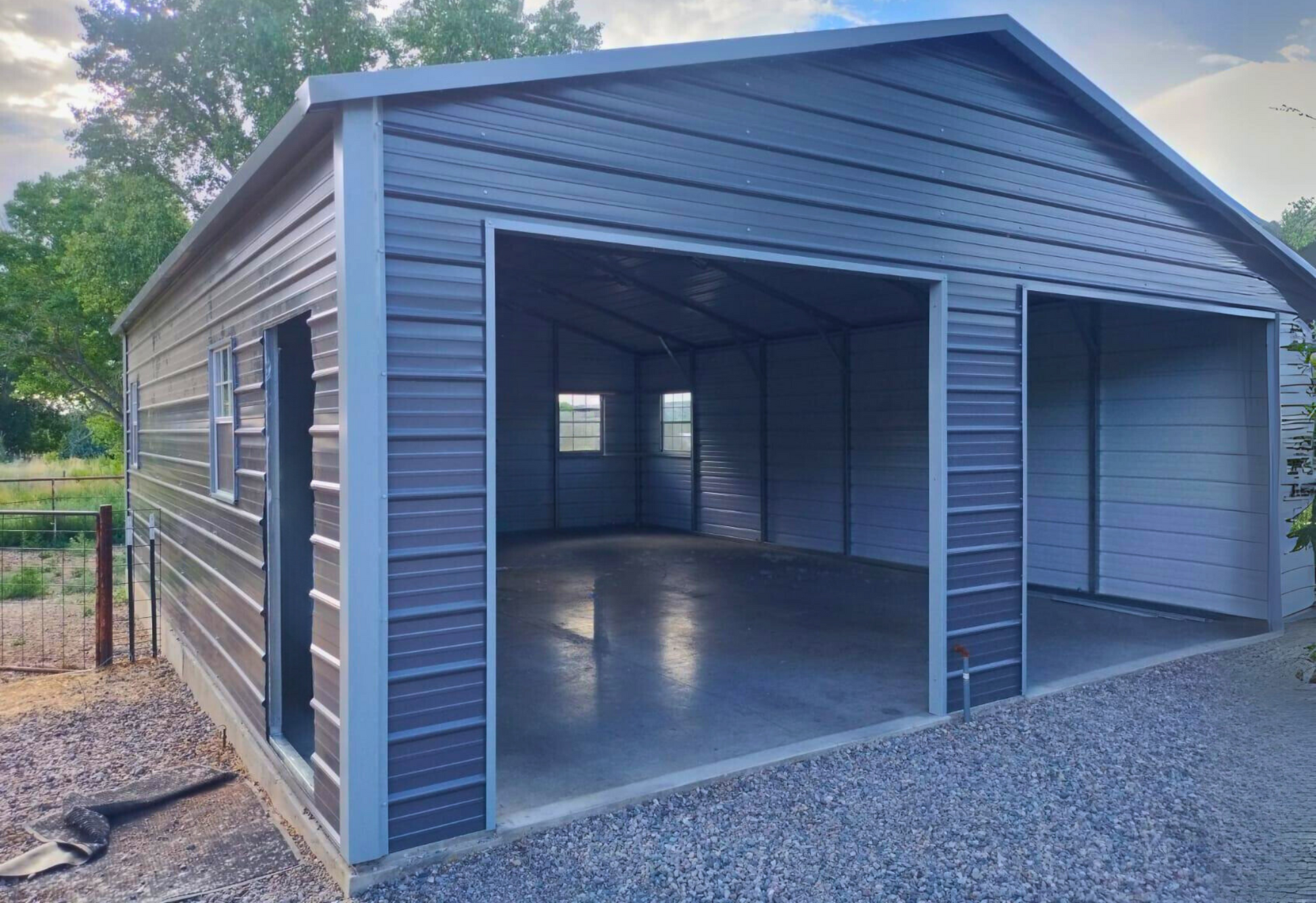 24'x30'x9' A-frame horizontal roof garage with 14 Ga. frame, 40PSF ground snow load, fully enclosed, featuring five 30" x 36" windows, one 36" x 80" walk-in door frame out, two 10' x 8' overhead door frame outs on front end, and thirty 1/2" concrete bolts.