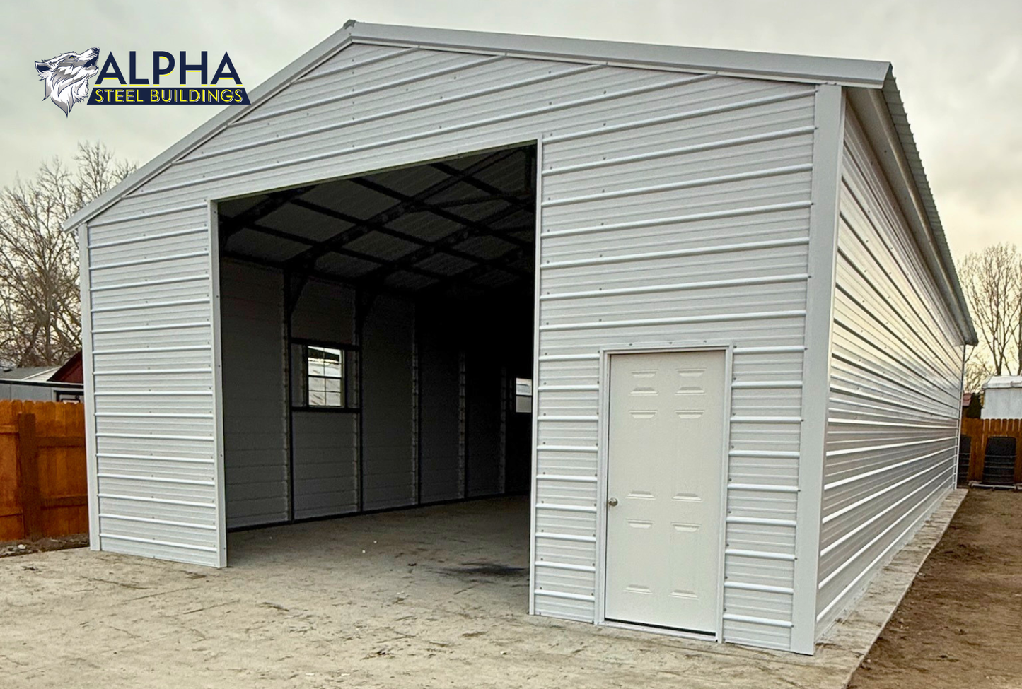 26x60x12 A-frame steel garage with vertical roof shown from the front right angle, fully enclosed with windows and 12x12 overhead door frame opening & a 36" x 80" walk-in door.