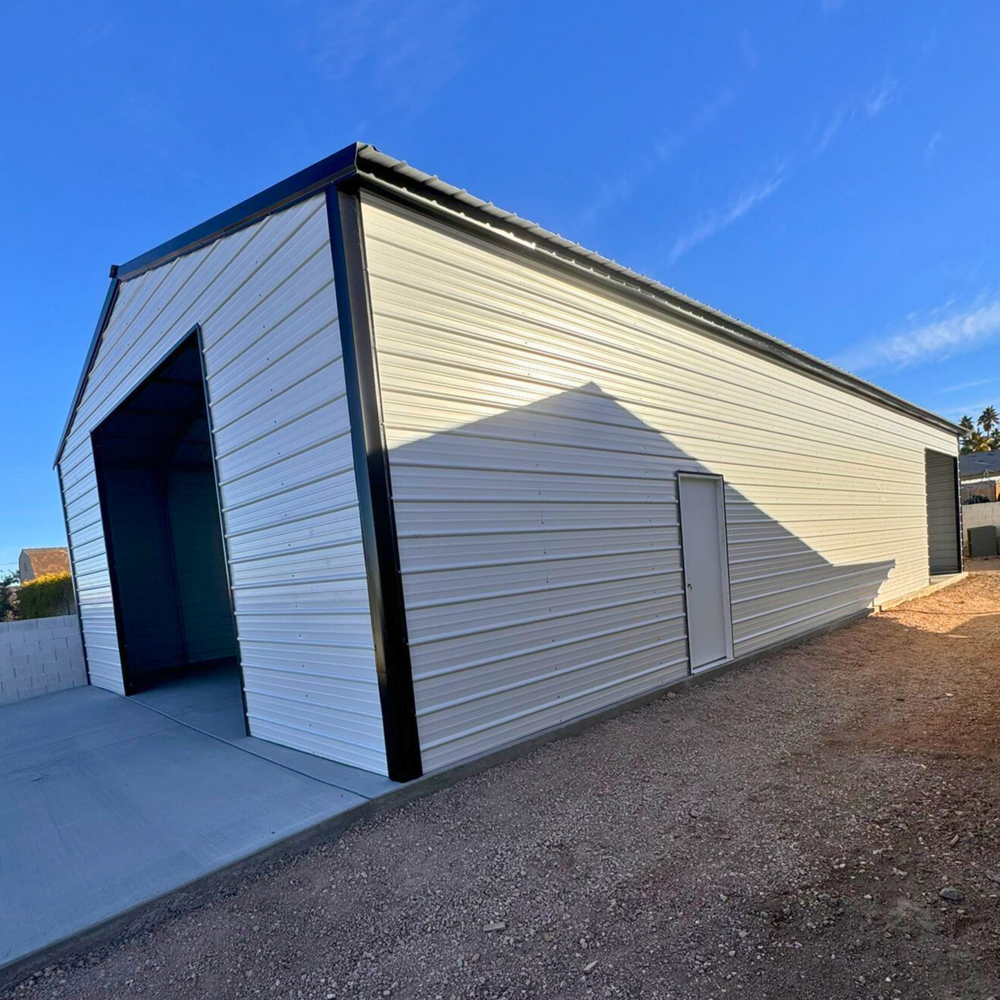 A-frame metal building with a vertical roof, fully enclosed on both sides and ends for secure storage and weather protection.