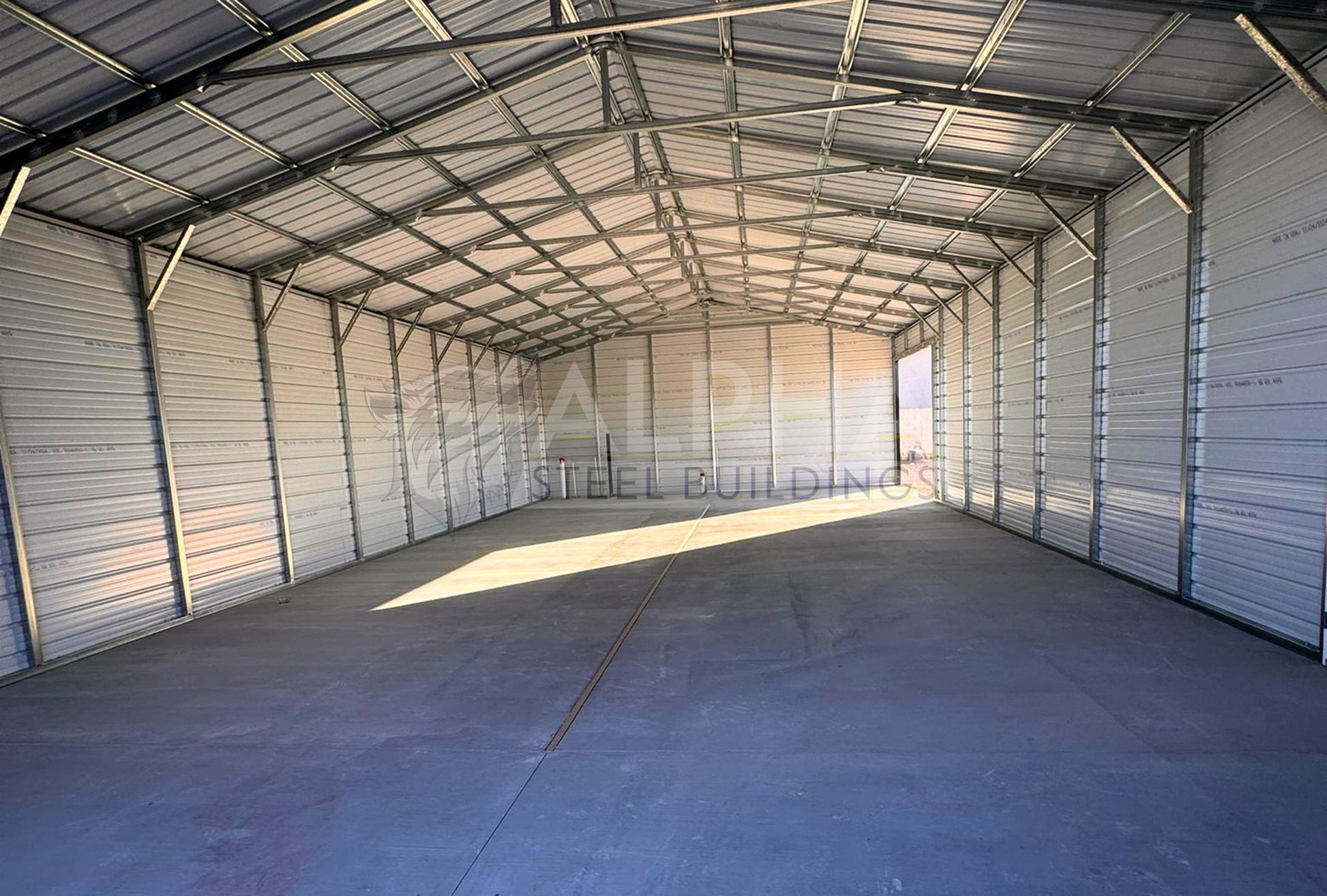 Interior view of 30' x 60' x 12' a-frame steel building with a vertical roof, fully enclosed on both sides and ends for secure storage and weather protection.