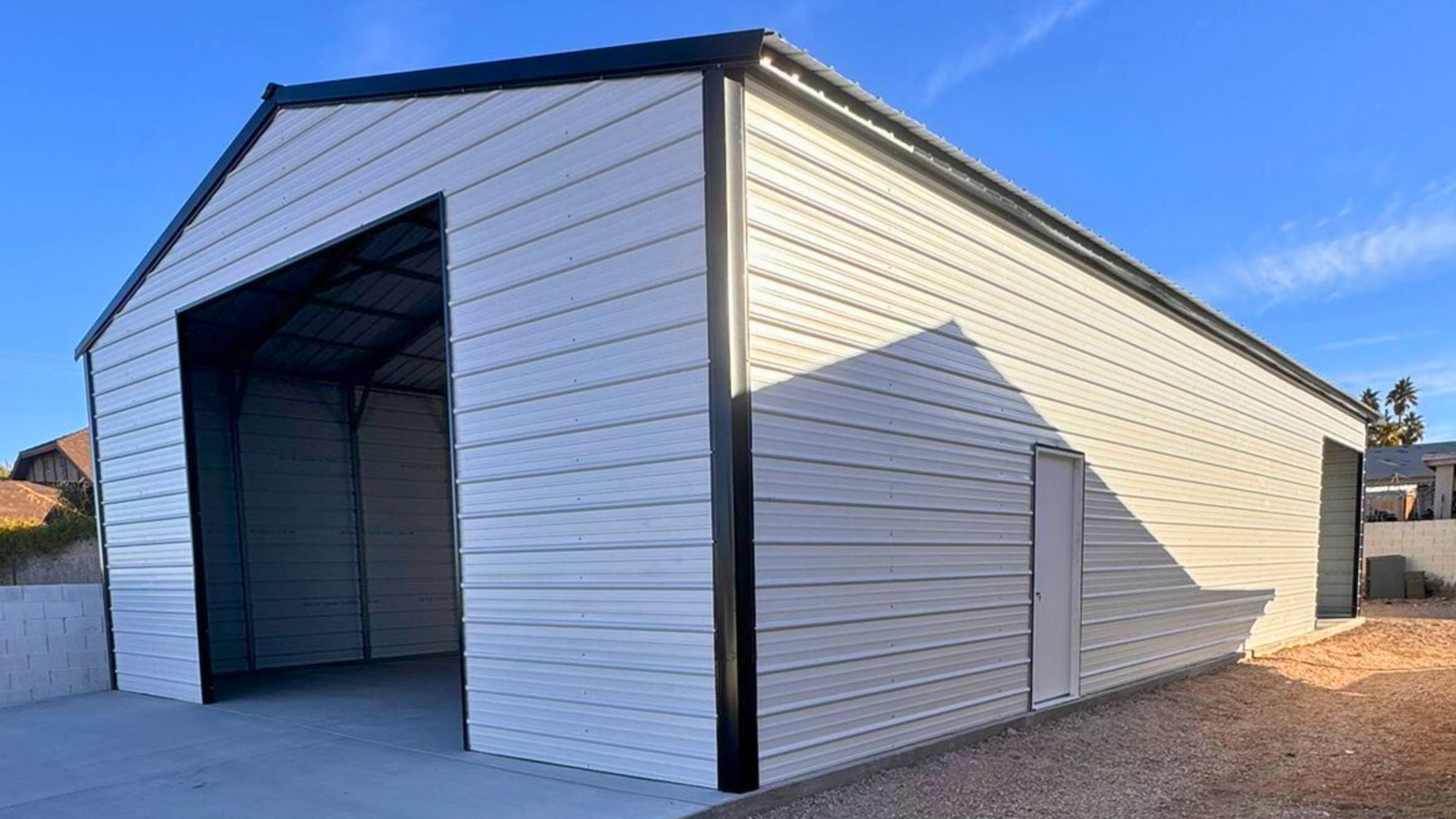 A-frame metal building with a vertical roof, fully enclosed on both sides and ends for secure storage and weather protection.