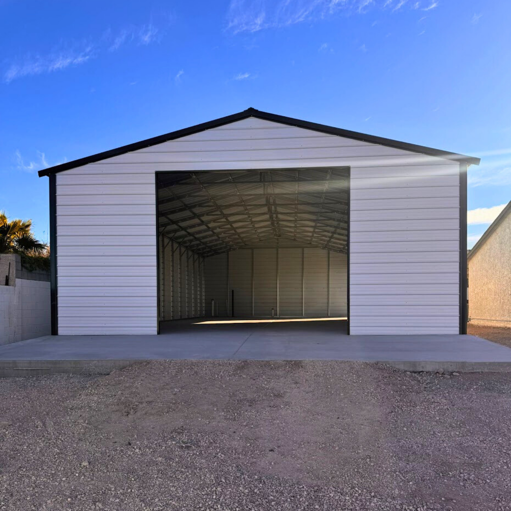 A-frame metal building with a vertical roof, fully enclosed on both sides and ends for secure storage and weather protection.