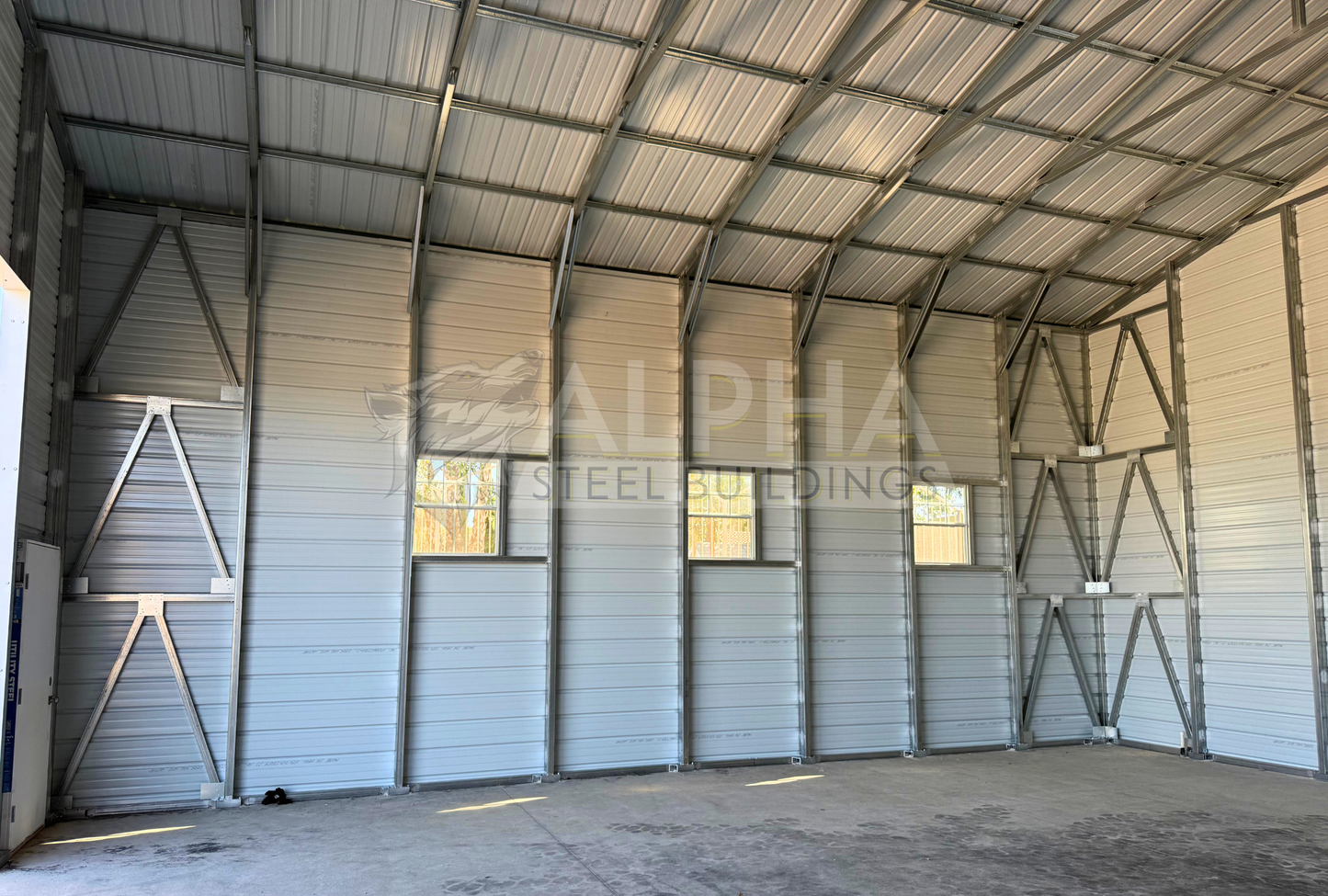 30x35x16 A-frame steel garage with vertical roof, horizontal panels, window frame outs, diagonal bracing and double leg posts, interior view
