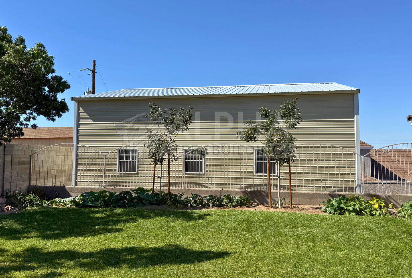 30x35x16 A-frame steel garage with vertical roof, horizontal side panels and window frame outs, side view
