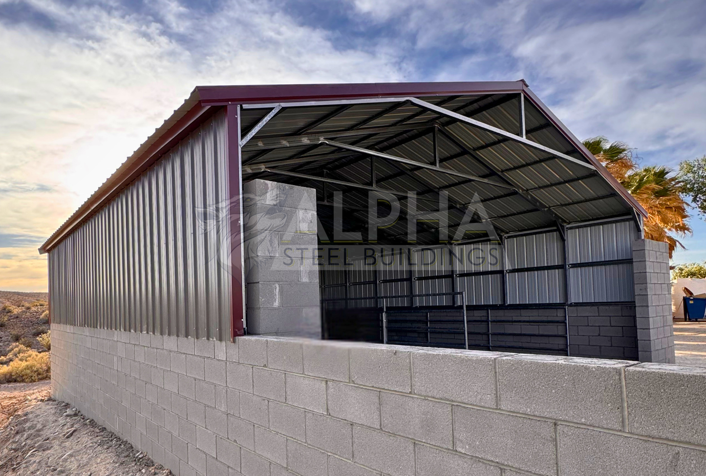 Front left angle view of a 30x35x6 A-frame steel agricultural building showing the open front, vertical roof, steel framing, and vertical side panels above the block wall.