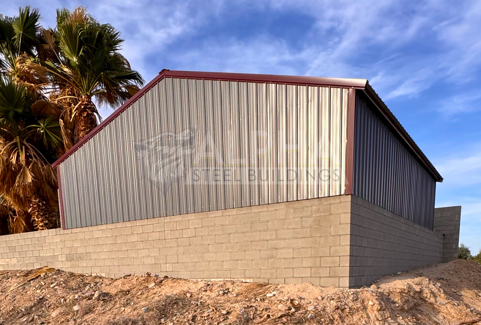Rear left angle view of a 30x35x6 A-frame steel agricultural building showing the enclosed rear end, vertical side panels, vertical roof, and existing block wall.