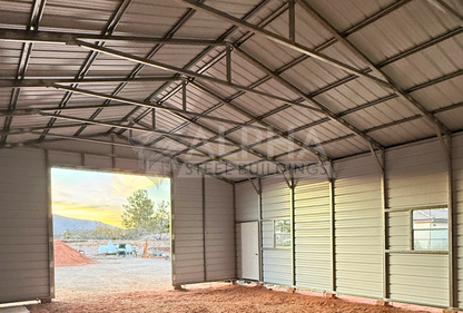 Interior angled view inside 30x40 steel garage looking toward the front wall and left side, showing structural framing and vertical roof system.