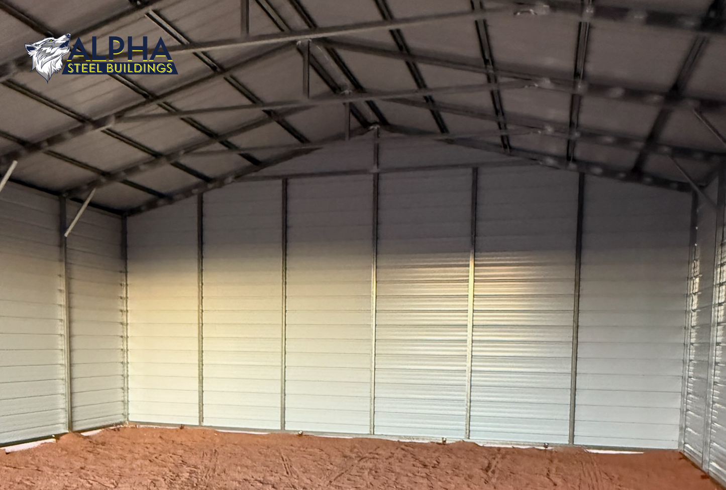 Interior view of 30x40 A-frame steel garage showing enclosed back wall, 14-gauge frame, and vertical roof panels.