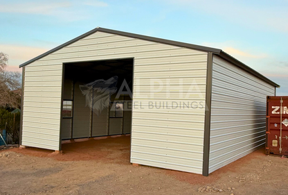 Front right angled view of 30x40 A-frame metal garage with vertical roof, fully enclosed sides, and framed overhead door opening.