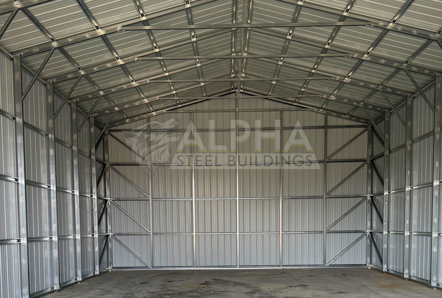 Internal back view of 30x45x16 a-frame steel shop with vertical roof, dual overhead door frame-outs, walk-in door, and closed vertical sides and ends.