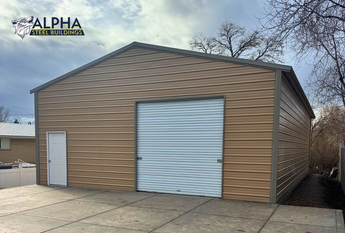 Front right angle view of enclosed 30x50 A-frame steel building with vertical roof and walk-in doors