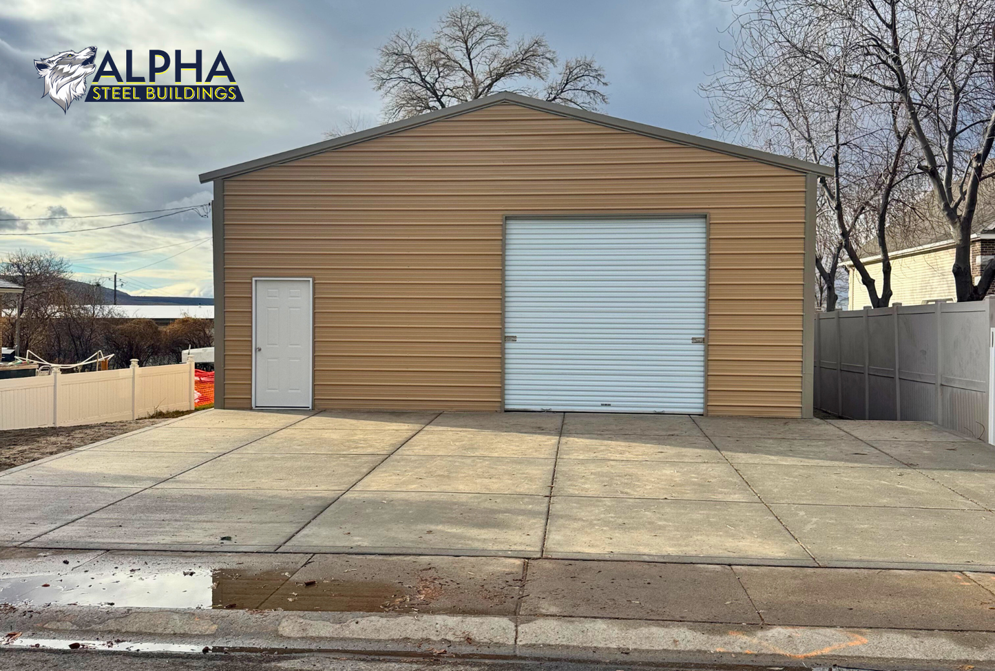 Front view of 30x50 A-frame steel building with 10x10 roll-up door, vertical roof, and fully enclosed sides and ends