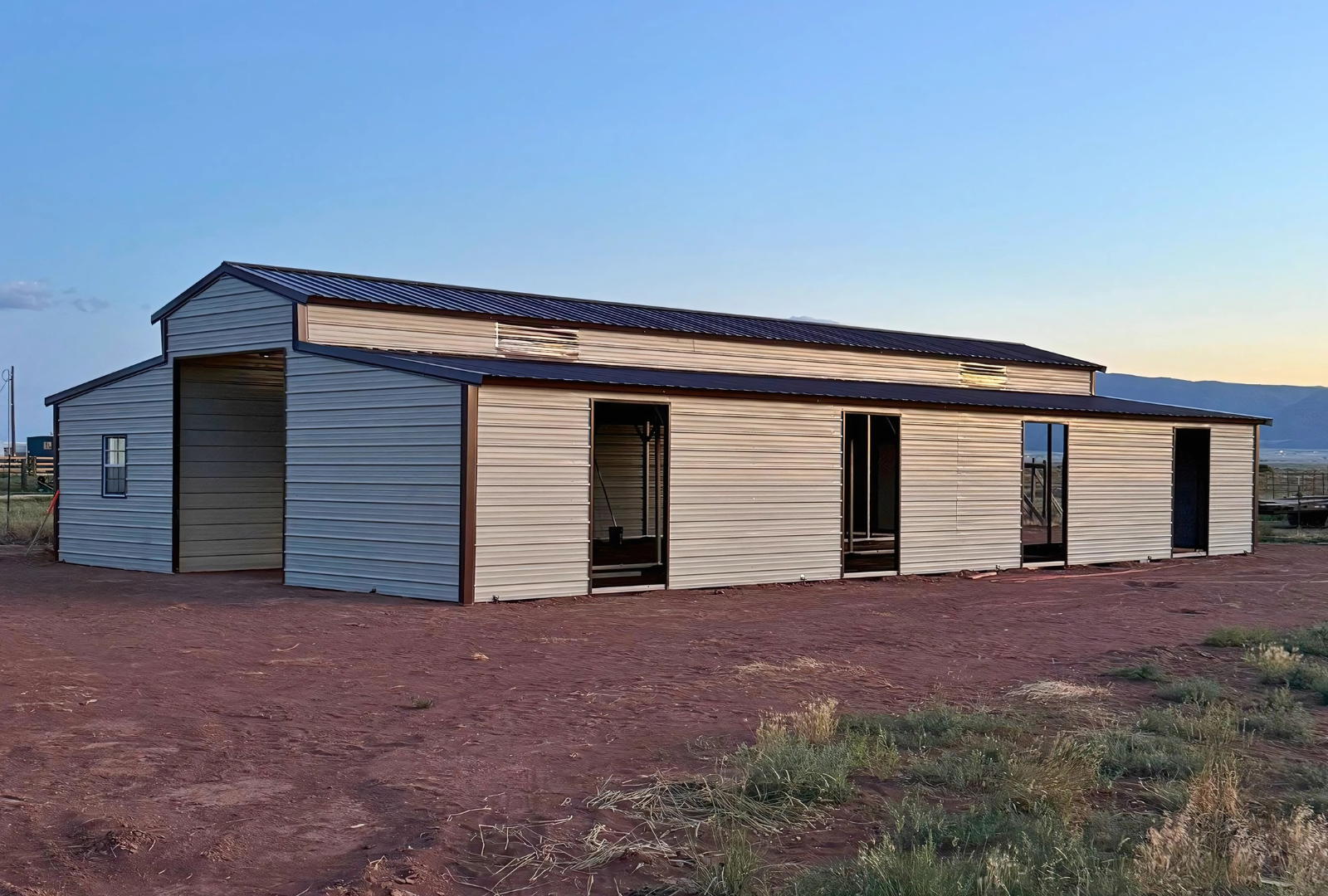 36'x60'x12' down to 10'-8' steel barn style with lean-tos, two panels under the eave, both sides closed, all ends closed, with 12' x 10' tack room, (2) 10' x 10' frame outs on the ends, (1) 10' x 10' frame out on the side of main, (4) 4' x 7' stall frame outs, (2) 30" x 36" windows, (2) 36" x 80" walk-in doors, right side view.