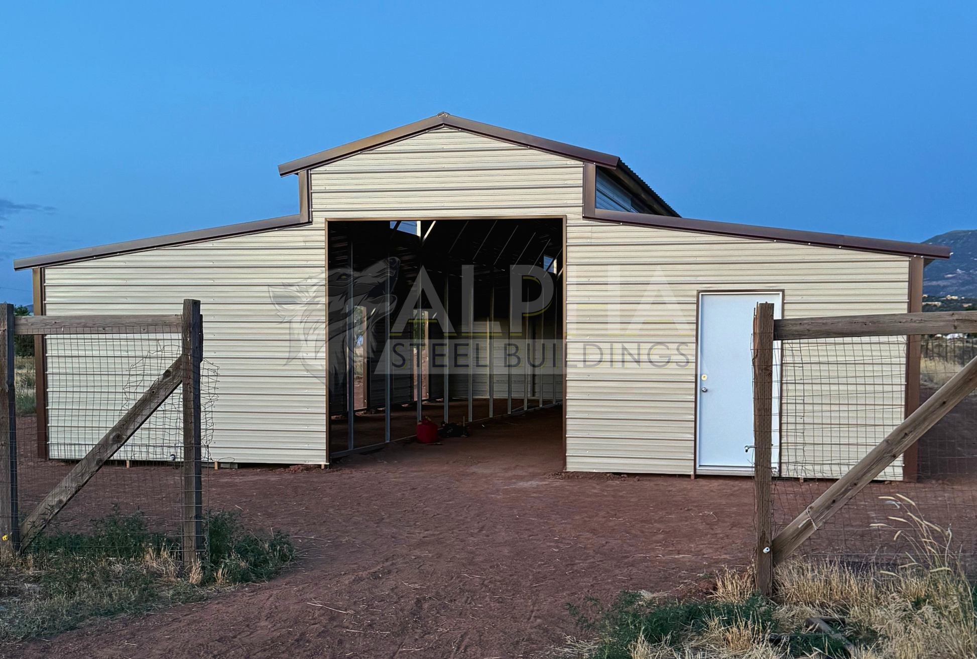 36x60x12 vertical roof steel barn with dual lean-tos and 10x10 frame-out, front view.