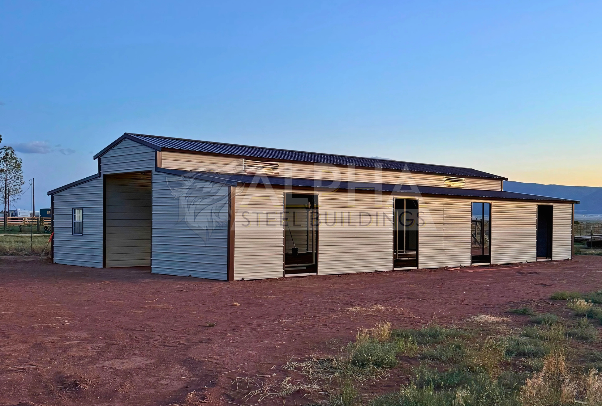 36x60x12 vertical roof steel barn with dual lean-tos and stall frame-outs, rear side view