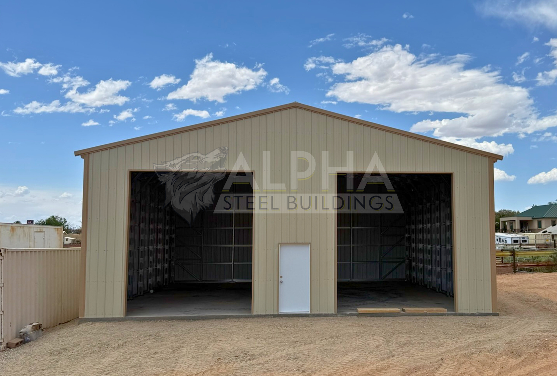 Front view of 40'x40'x15' steel shop features ladder style truss design, vertical roof, fully enclosed with vertical siding, one 36" x 80" walk-in door, and two 12' x 14' overhead door frame outs on the end. 