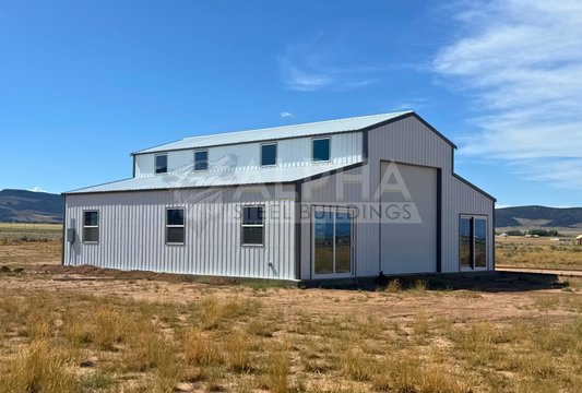 Front corner view of a 44'x45' barn style steel building featuring a vertical roof, enclosed lean-to sections, multiple windows, glass entry doors, and a 14' overhead garage door.