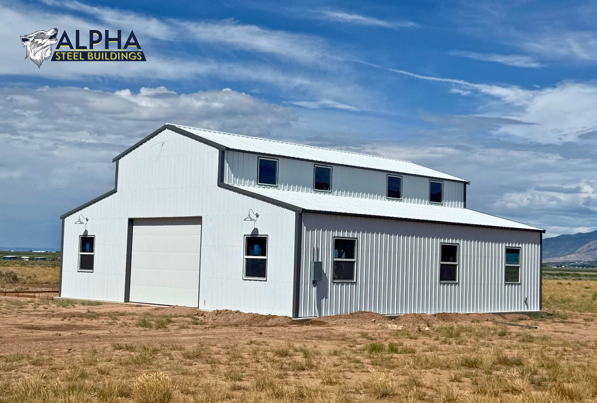 Rear corner view of a 44'x45' barn style steel building with a vertical roof, enclosed lean-to sections, multiple windows, and a 14' overhead garage door.
