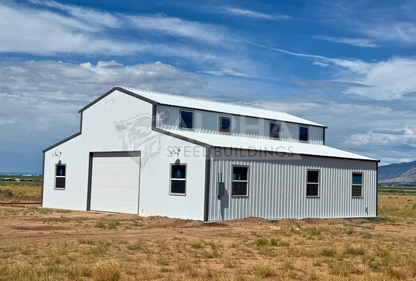 Rear corner view of a 44'x45' barn style steel building with a vertical roof, enclosed lean-to sections, multiple windows, and a 14' overhead garage door.