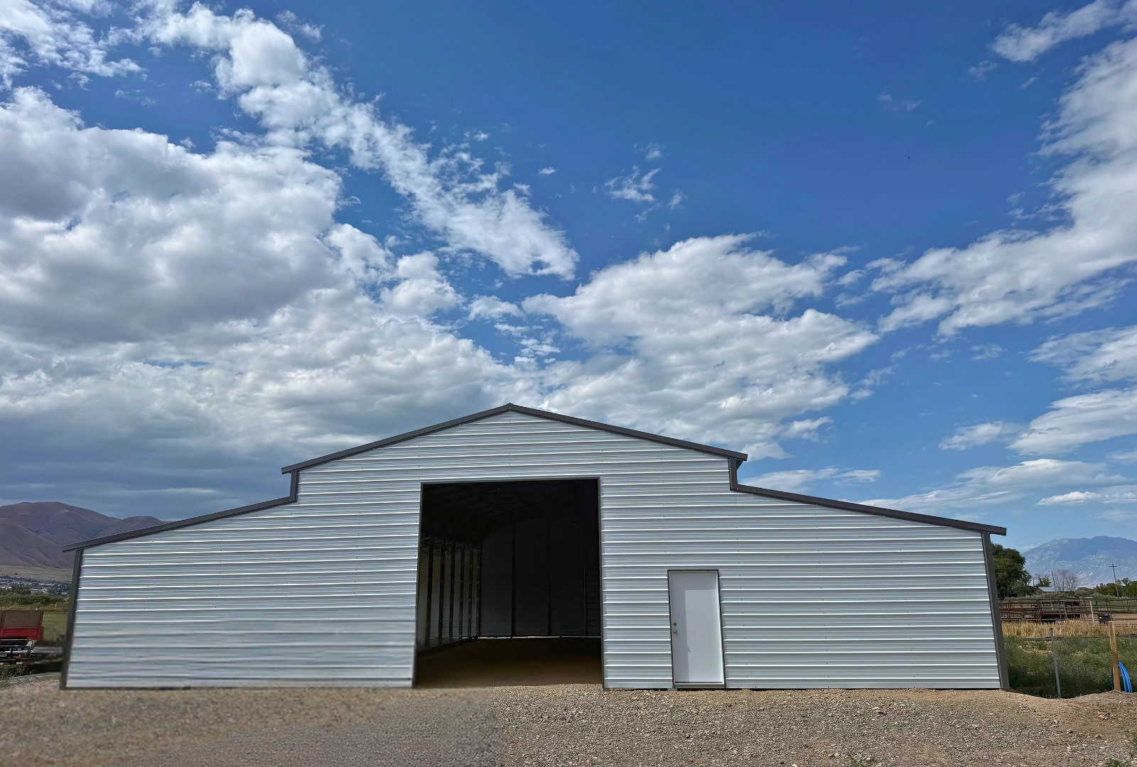 60'x60'x14' down to 12'-9' steel barn style with lean-tos, two panels under the eave, both sides closed, all ends closed, with 12' x 15' wash bay, (1) 12' x 13' frame out on the end, (1) 9' x 7' frame out on the end, (1) 14'2" x 12' wash bay frame out on the side, (4)  9'2" x 8' stall frame outs on the side of left lean-to, (2) 14'2" x 8' frame outs on the side of right lean-to, (1) 36" x 80" walk-in door, front view.
