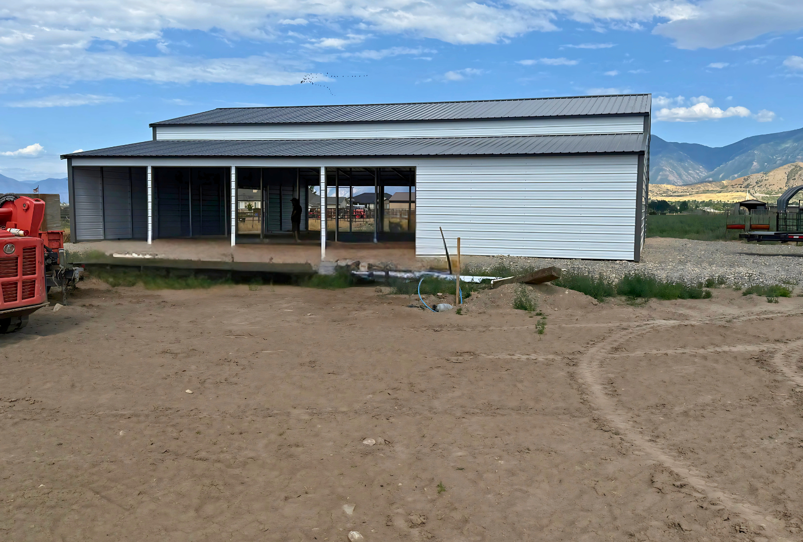 60'x60'x14' down to 12'-9' steel barn style with lean-tos, two panels under the eave, both sides closed, all ends closed, with 12' x 15' wash bay, (1) 12' x 13' frame out on the end, (1) 9' x 7' frame out on the end, (1) 14'2" x 12' wash bay frame out on the side, (4)  9'2" x 8' stall frame outs on the side of left lean-to, (2) 14'2" x 8' frame outs on the side of right lean-to, (1) 36" x 80" walk-in door, left view.