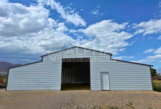60x60x14 vertical roof steel barn with dual lean-tos, large frame-out and walk-in door, front view