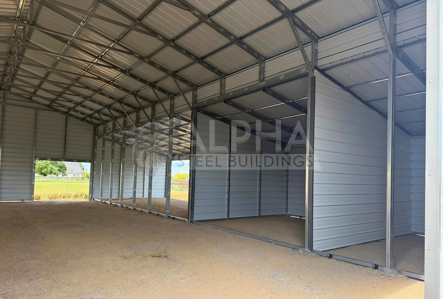 60x60x14 vertical roof steel barn showing steel framing, wash bay walls and lean-to sections, interior view.
