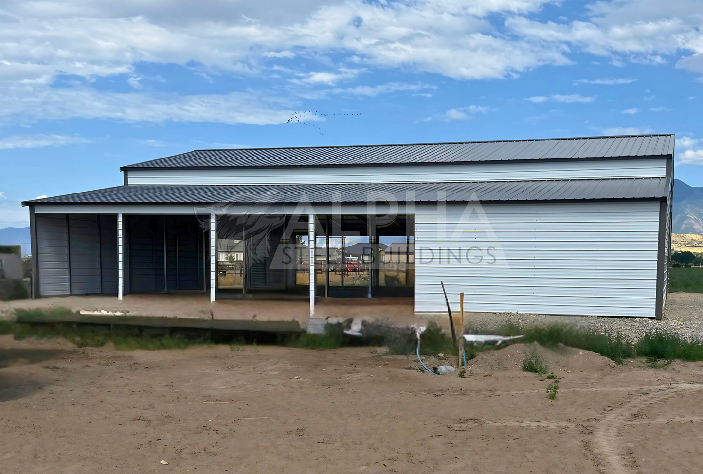 60x60x14 vertical roof steel barn with dual lean-tos and multiple stall frame-outs, left side view.