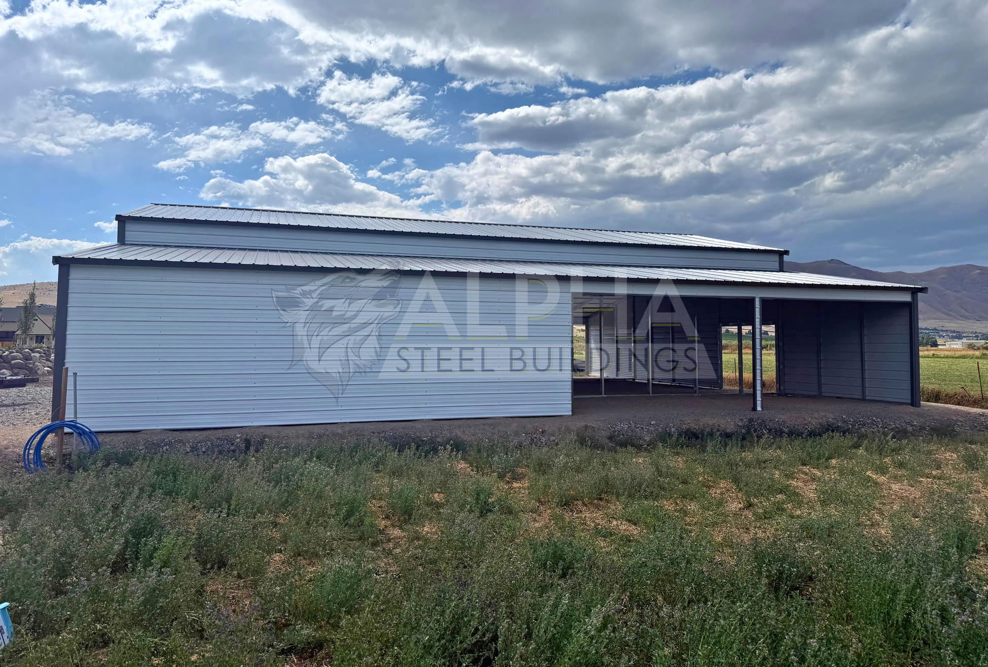 60x60x14 vertical roof steel barn with dual lean-tos and stall frame-outs, right side view