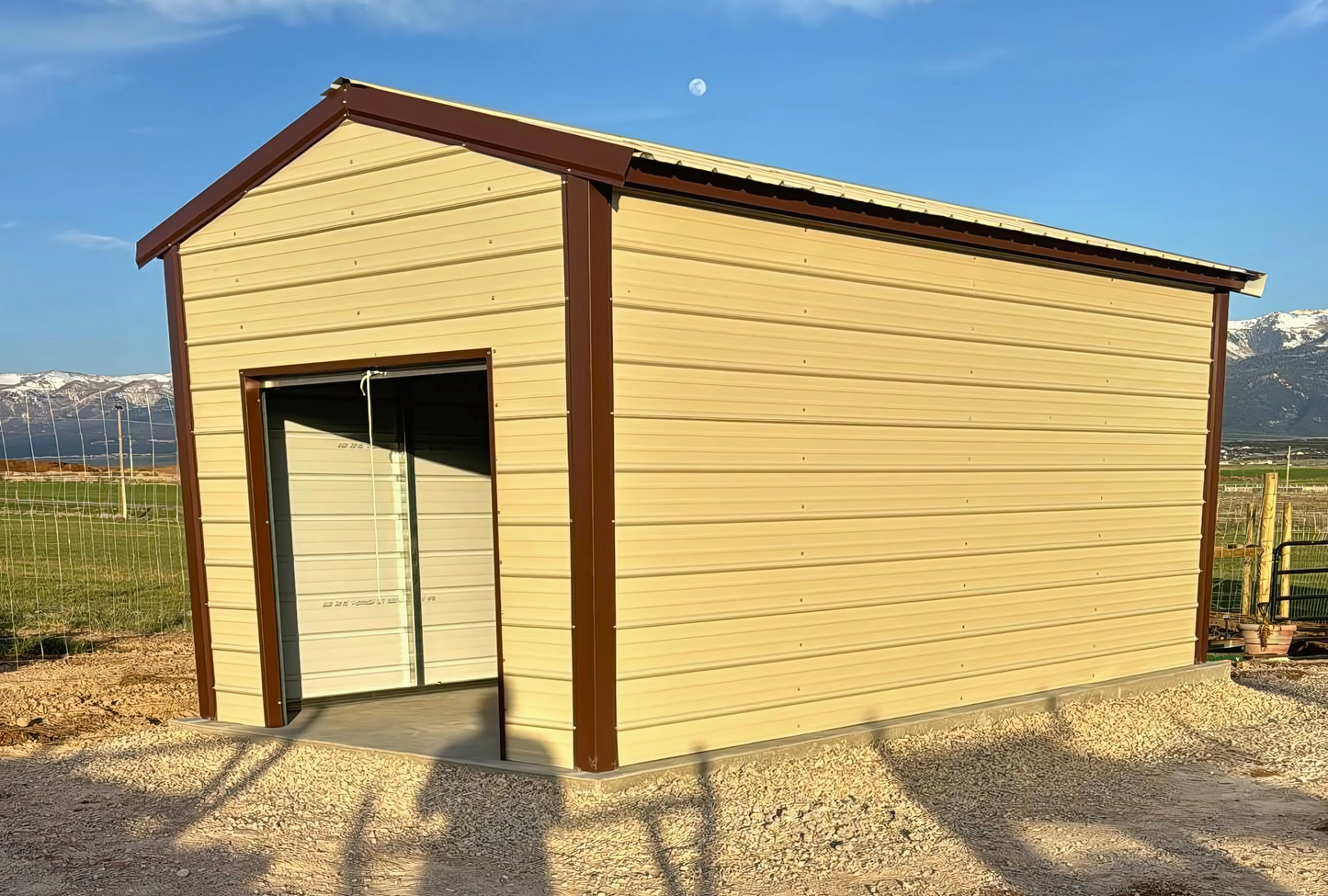 10'x20'x8' a-frame style vertical roof, heavy duty to withstand the snow, closed on both sides and the ends, with one walk in door, two windows & one 6' x 6' roll-up door.