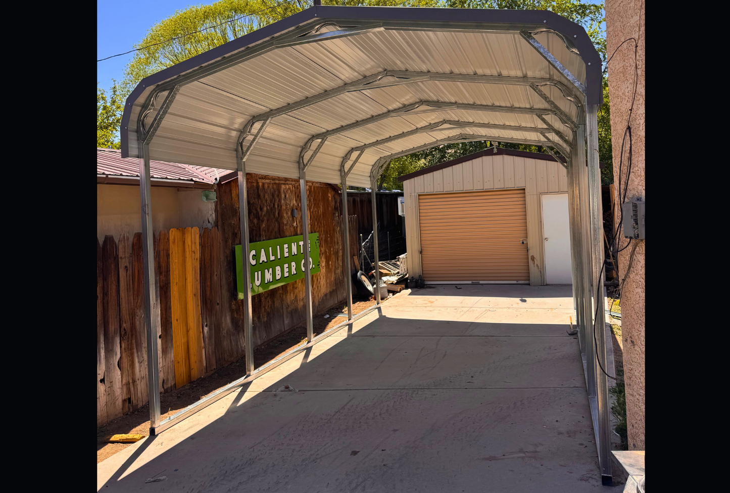 12'x20'x8' charcoal gray roof with open sides for one vehicle only, front right sideways view.