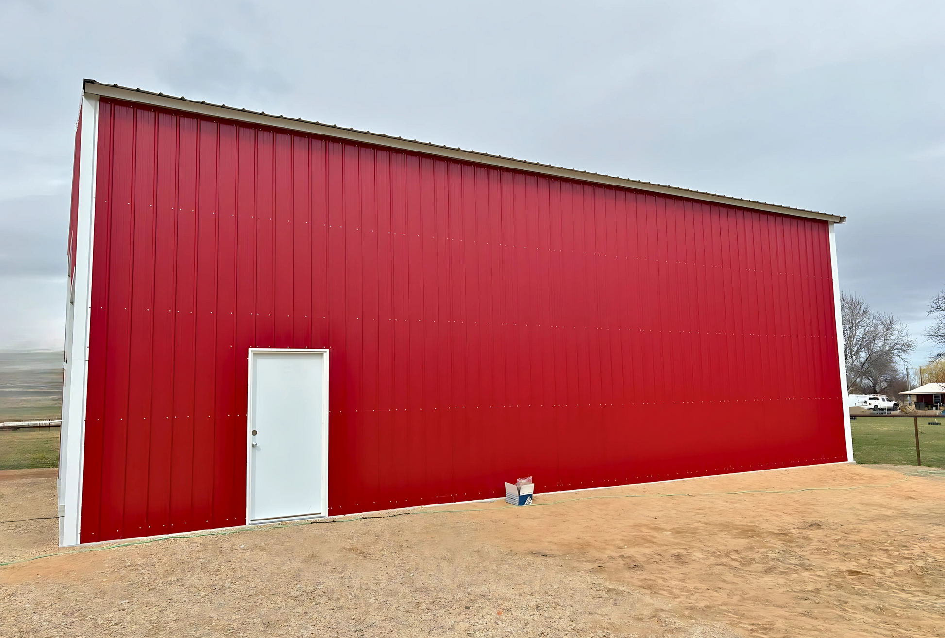 Angled side view of 30x45x16 A-frame steel building showing vertical siding.