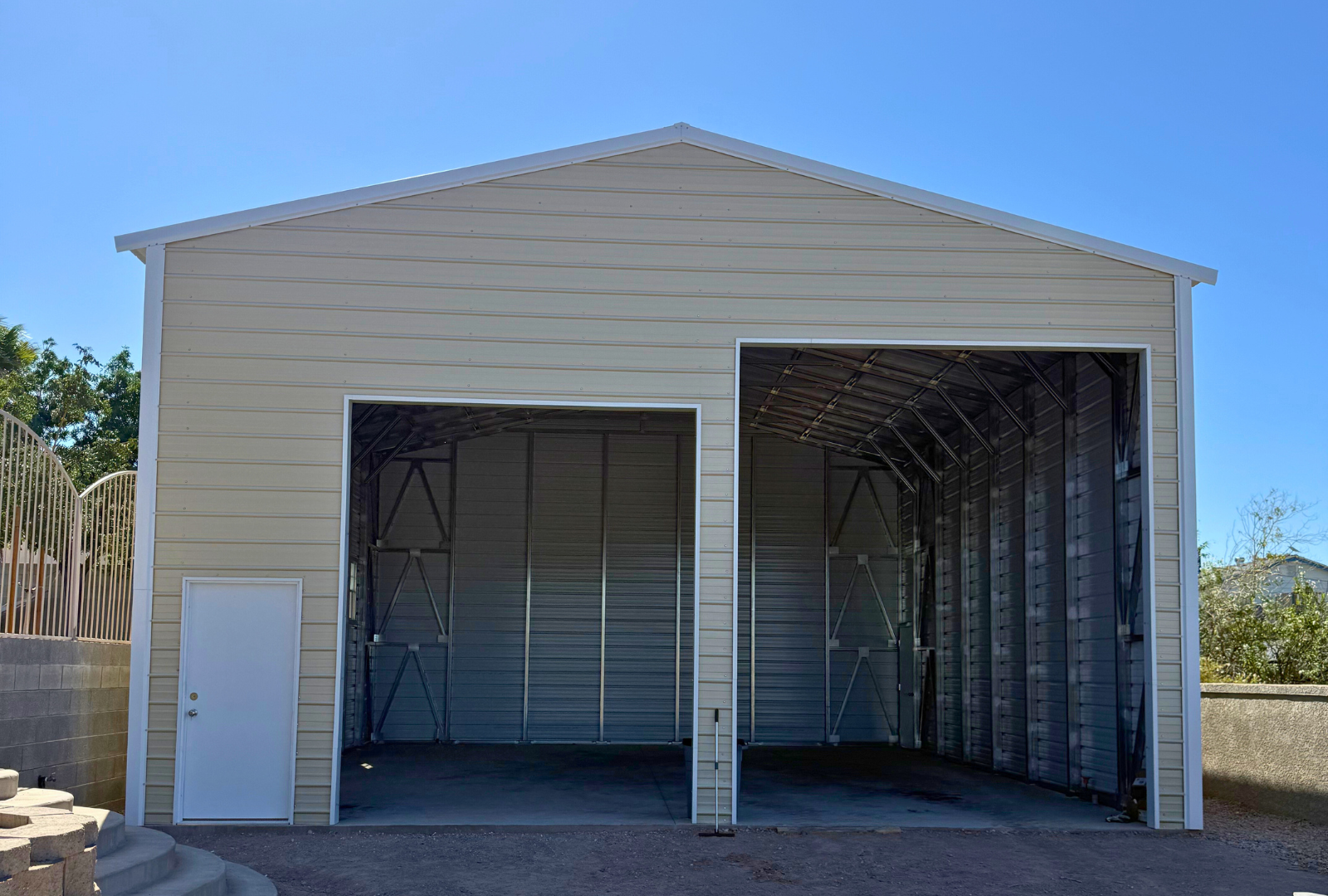 A-frame steel building, 30x35 with 16-foot height and double legs, vertical roof, enclosed sides and ends, overhead door frame-outs (12x14 and 10x12), plus walk-in doors and windows. Built with 14-gauge framing and rated for 30 PSF ground snow load, front view.