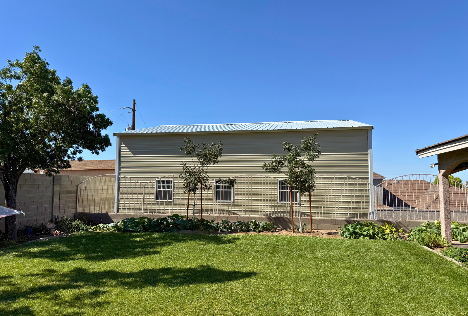A-frame steel building, 30x35 with 16-foot height and double legs, vertical roof, enclosed sides and ends, overhead door frame-outs (12x14 and 10x12), plus walk-in doors and windows. Built with 14-gauge framing and rated for 30 PSF ground snow load, left side view.